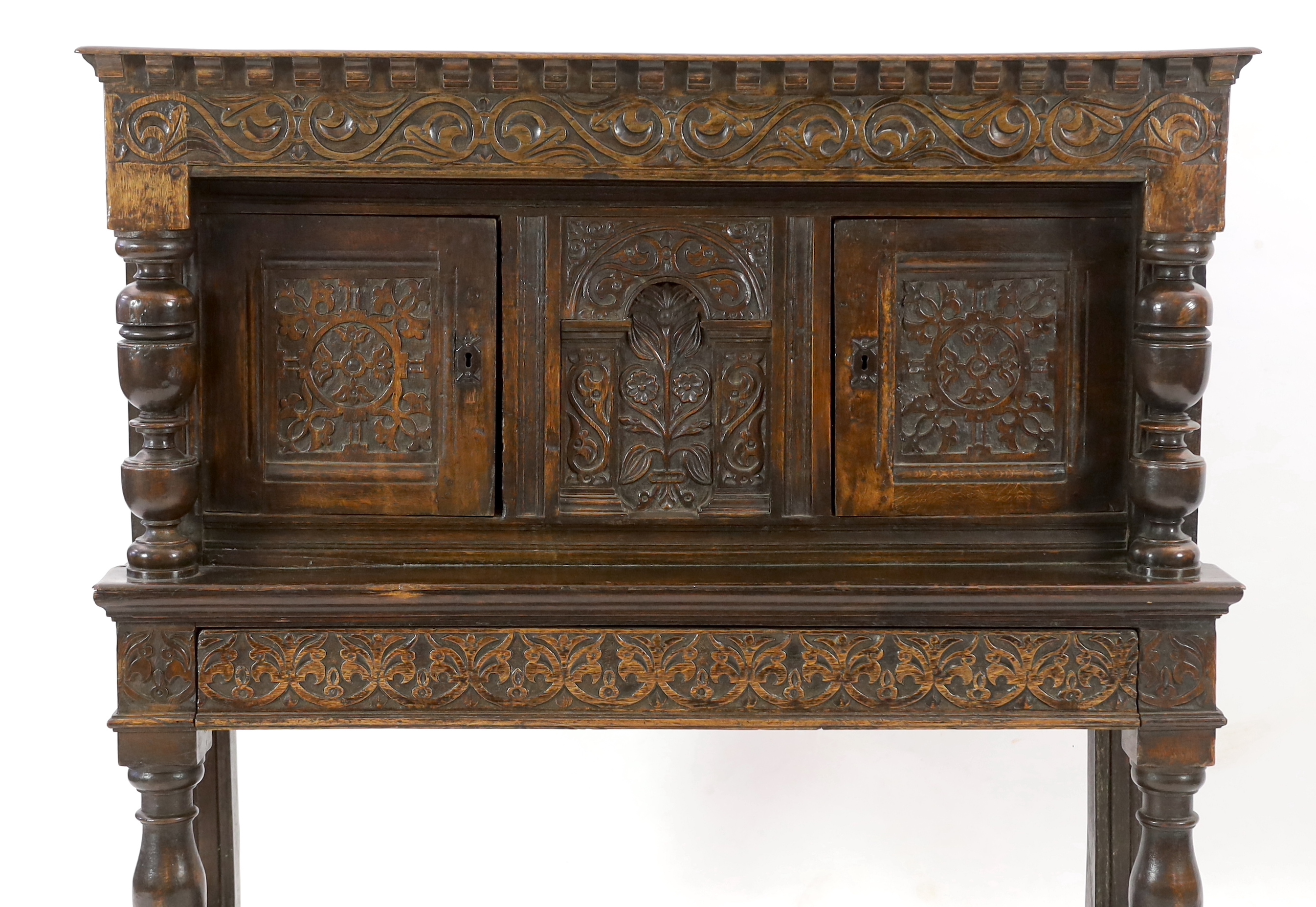 A Charles I carved oak court cupboard